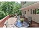 Relax on this home's back deck, complete with patio furniture and a view of the lush backyard trees at 173 Rocky River Rd, Mooresville, NC 28115