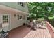 Enjoy peaceful outdoor living on this home's spacious back deck with patio furniture and wooded views at 173 Rocky River Rd, Mooresville, NC 28115