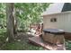 Backyard features a built-in jacuzzi, trees, and outdoor seating on wooden deck at 173 Rocky River Rd, Mooresville, NC 28115