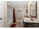 Cozy bathroom featuring a shower-tub combo, tile flooring, vanity, and neutral paint at 173 Rocky River Rd, Mooresville, NC 28115