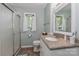 Bathroom with updated vanity, countertop, tile floors and glass shower door at 173 Rocky River Rd, Mooresville, NC 28115