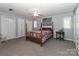 This lovely bedroom features carpet, ceiling fan, and attached closets for ample storage space at 173 Rocky River Rd, Mooresville, NC 28115
