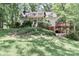 View of the home from the front, showcasing the landscaping, a quaint front porch and a side deck at 173 Rocky River Rd, Mooresville, NC 28115