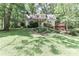 Beautiful home with a well-manicured lawn and mature trees, offering a serene and private setting at 173 Rocky River Rd, Mooresville, NC 28115
