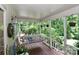 Cozy covered porch featuring a porch swing, plants, and a tranquil view of the surrounding greenery at 173 Rocky River Rd, Mooresville, NC 28115