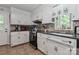 Traditional kitchen features tile flooring, white cabinetry, and stainless steel appliances at 173 Rocky River Rd, Mooresville, NC 28115