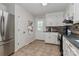 Traditional kitchen features tile flooring, white cabinetry, and stainless steel appliances at 173 Rocky River Rd, Mooresville, NC 28115