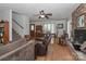 Open living room with staircase, hardwood floors, brick fireplace, and comfortable seating at 173 Rocky River Rd, Mooresville, NC 28115