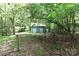 Exterior view of a blue outbuilding with white trim and wooden gate at 173 Rocky River Rd, Mooresville, NC 28115