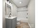 Updated bathroom featuring a modern vanity and a tiled shower-tub combination at 1746 2Nd Street Sw Pl, Hickory, NC 28602