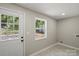 Bright bathroom with a modern door and window, neutral paint and tiled floors at 1746 2Nd Street Sw Pl, Hickory, NC 28602