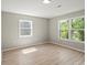 Well-lit bedroom featuring new modern flooring, windows with natural light, and neutral paint at 1746 2Nd Street Sw Pl, Hickory, NC 28602