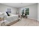 Light-filled bedroom showcasing a bed with accent pillows and a bench beneath a window at 1746 2Nd Street Sw Pl, Hickory, NC 28602