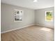 Bright bedroom with light-colored walls, modern flooring, and natural light from two windows at 1746 2Nd Street Sw Pl, Hickory, NC 28602
