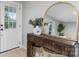Entryway with a wood console table, gold mirror, vase with greenery and front door at 1746 2Nd Street Sw Pl, Hickory, NC 28602