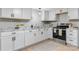 Well-lit kitchen with white cabinetry, marble countertops, and modern stainless steel appliances at 1746 2Nd Street Sw Pl, Hickory, NC 28602