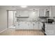 Updated kitchen with granite countertops, white cabinets, stainless steel sink, and wood-look floors at 1746 2Nd Street Sw Pl, Hickory, NC 28602
