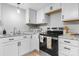 Clean kitchen with white cabinets, marble countertops, stainless steel appliances, and modern fixtures at 1746 2Nd Street Sw Pl, Hickory, NC 28602