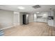 Open-concept kitchen and living area with new floors and stainless-steel refrigerator at 1746 2Nd Street Sw Pl, Hickory, NC 28602
