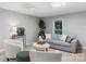 Bright living room with neutral tones featuring a gray sofa, round ottoman, and stylish decor at 1746 2Nd Street Sw Pl, Hickory, NC 28602