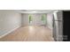 Bright living room boasts new floors, fresh paint, and stainless-steel refrigerator at 1746 2Nd Street Sw Pl, Hickory, NC 28602