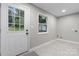 Bright, clean mud room with white door, window, tile floors and neutral gray walls at 1746 2Nd Street Sw Pl, Hickory, NC 28602