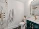 Stylish bathroom featuring marble shower, herringbone floors, green vanity, and gold fixtures at 1817 Rush Wind Dr, Charlotte, NC 28206