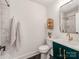Modern bathroom featuring marble shower, herringbone floors, green vanity, and gold fixtures at 1817 Rush Wind Dr, Charlotte, NC 28206