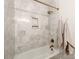 Elegant bathroom features hexagon marble tile surround, niche, and modern gold fixtures at 1817 Rush Wind Dr, Charlotte, NC 28206