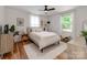 Bright bedroom with wood floors, white walls, a ceiling fan, and lots of natural light at 1817 Rush Wind Dr, Charlotte, NC 28206
