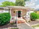 Close-up of the home's entrance with a welcoming porch, hanging plants, and detailed brickwork at 1817 Rush Wind Dr, Charlotte, NC 28206
