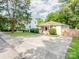 Inviting single-story home with a spacious driveway, lush greenery, and curb appeal at 1817 Rush Wind Dr, Charlotte, NC 28206