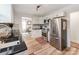 Modern kitchen with stainless steel appliances, white cabinetry, and a view of the dining area at 1817 Rush Wind Dr, Charlotte, NC 28206