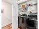 Bright laundry room with modern washer/dryer and organized shelving for storage at 1817 Rush Wind Dr, Charlotte, NC 28206