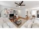 Comfortable living room featuring hardwood floors, a ceiling fan, and a seamless connection to the dining area at 1817 Rush Wind Dr, Charlotte, NC 28206