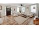 Spacious living area with hardwood floors, white sofas, large windows, and modern furnishings at 1817 Rush Wind Dr, Charlotte, NC 28206