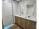 Bathroom with double sink vanity and wooden cabinets, white marble countertops, and framed mirrors at 188 Trivette Rd, Harmony, NC 28634