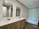 Bright bathroom features double sinks, white countertops, and a separate tub and shower at 188 Trivette Rd, Harmony, NC 28634
