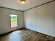 Bright bedroom with hardwood floors, a window with a view, and neutral-colored walls at 188 Trivette Rd, Harmony, NC 28634