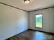 Bedroom features hardwood floors, a window with a view, and neutral-colored walls at 188 Trivette Rd, Harmony, NC 28634