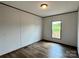 Bedroom features hardwood floors, a window with a view, and neutral-colored walls at 188 Trivette Rd, Harmony, NC 28634