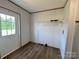 Bright laundry area includes a wood grain floor, storage shelf, and door to the outside at 188 Trivette Rd, Harmony, NC 28634
