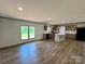 Open-concept living area flows into the kitchen, complete with wood-look floors and ample natural light at 188 Trivette Rd, Harmony, NC 28634