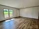 Open living room with hardwood flooring, natural light, and a view of the outdoors at 188 Trivette Rd, Harmony, NC 28634