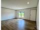 Inviting living room featuring wood-look flooring, neutral walls, and natural light from windows at 188 Trivette Rd, Harmony, NC 28634