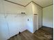 Utility room with shelving, washer and dryer hookups, and wood-look flooring at 188 Trivette Rd, Harmony, NC 28634
