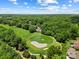 Gorgeous aerial view overlooking the golf course, water feature, and surrounding trees and greenery at 19946 River Falls Dr, Davidson, NC 28036