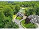 Beautiful aerial view showcasing the home, manicured lawn, mature landscaping and proximity to the golf course at 19946 River Falls Dr, Davidson, NC 28036