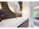 Modern bathroom featuring a stylish vanity with elegant fixtures and a decorative mirror at 19946 River Falls Dr, Davidson, NC 28036