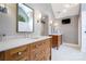 Elegant bathroom with double sinks, marble countertops, and custom wooden cabinetry at 19946 River Falls Dr, Davidson, NC 28036